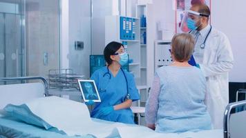 Nurse in mask explaining diagnostic photo