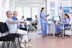 Invalid senior woman in hospital lobby photo