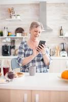 Elderly woman reading message photo