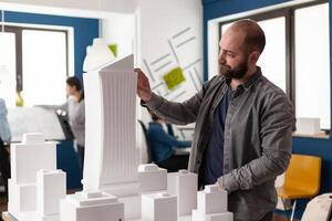 Architect man looking at design in professional office photo