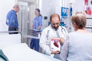 Doctor explaining coronary artery disease photo