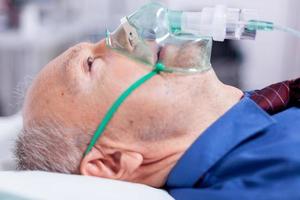 Old man breathing with oxygen mask photo
