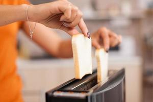 Roasting bread on electric toaster photo