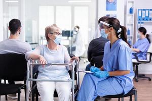 Handicapped woman discussing with medical staff photo