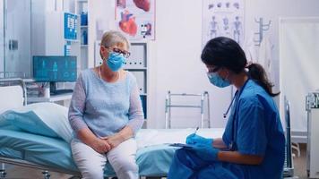 Nurse talking with old senior patient