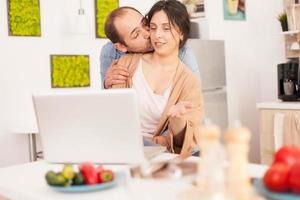 Husband kissing wife cheek photo