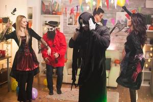 Grim reaper talking on the phone at halloween celebration photo