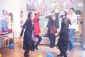 Grim reaper and cheerful witch dancing photo