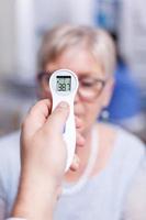 Senior patient having high temperature photo