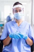 Medical assistant with visor and face mask photo