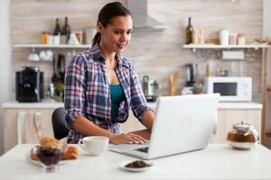 Smiling and using laptop photo