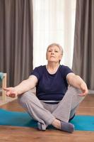 Portrait of old woman practicing yoga photo