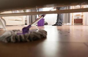 Cleaning dust under sofa photo