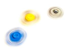 fidget hand spinner spinning on white background photo