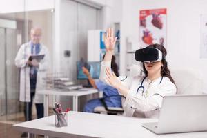 Doctor wearing high tech virtual reality goggles photo