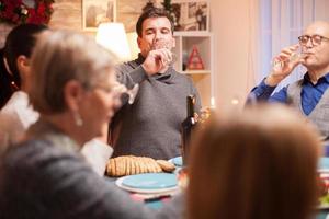 Happy male and his father drinking a glass of wine photo