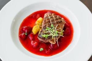 Steak from fillet of a duck with caramelized strawberry photo