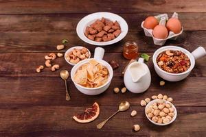 Tasty and nutritious breakfast with granola, cereals and nuts. Healthy food photo