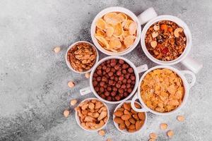 Tasty and nutritious breakfast with granola, cereals and nuts. Healthy food photo