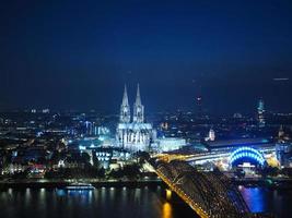 Aerial night view of St Peter Cathedral and Hohenzollern Bridge photo