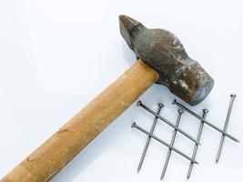 Old hammer and nails. Objects on a light background photo