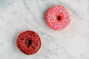Delicious chocolate donuts on a gray concrete surface. photo