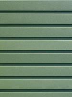 Green corrugated steel sheet with vertical guides. photo