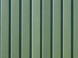 Green corrugated steel sheet with vertical guides. photo