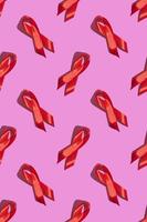 International AIDS Day. Red ribbon with a hard shadow on a pink background. AIDS awareness concept. Vertical. Pattern photo