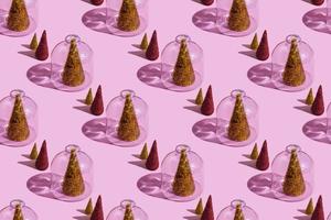 Christmas tree under glass on a pink background. Christmas concepts with copy space. New year and christmas concept in quarantine. Quarantine sample. photo