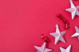 Stars and spirals, streamers on a red background with copy space photo