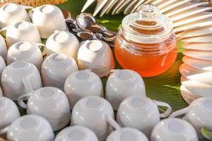 white cup for tea with honey jar. photo