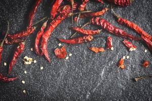 Dried chili on dark background - Red dried chilli pepper cayenne on a stone photo