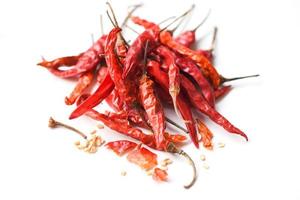 Dried chili on white background - pile of red dried chilli pepper cayenne photo