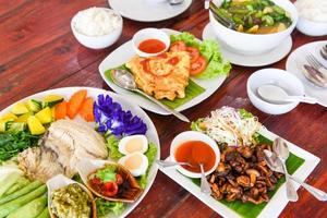 thai food top view , asian food served on wooden table setting with plate menu in thailand photo
