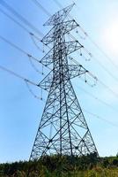 High voltage post, High voltage tower sky background on the mountain forest, Electricity poles and electric power transmission lines against countryside photo