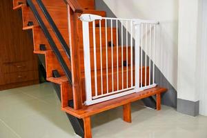 Baby gate safety door, white fence for safety children on stairs or dog gate. photo