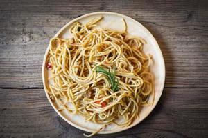 spaghetti pasta on tray wooden table background easy cooking at home, Homemade Spaghetti top view. photo