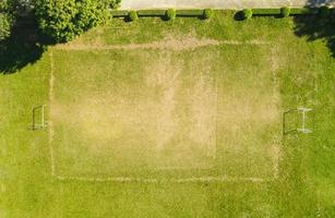 Aerial view field nature green soccer field background, top view football field from above in the countryside, Bird eye view futsal field  with goal photo