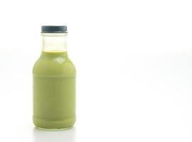 matcha green tea latte in glass bottle photo