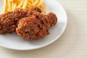 spicy Korean fried chicken with fries photo