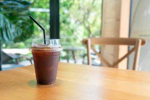 iced black coffee takeaway glass on table in coffee shop cafe restaurant photo