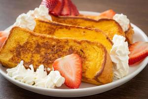 french toast with fresh strawberry and whipping cream photo