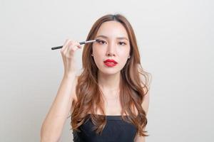 portrait beautiful woman with makeup eye brush photo