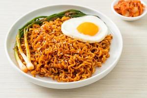 dried Korean spicy instant noodles with fried egg photo