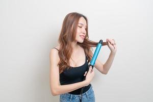 portrait beautiful Asian woman using hair curler or curling iron photo