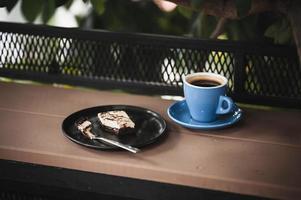 Brownie and hot coffee on wood bar photo