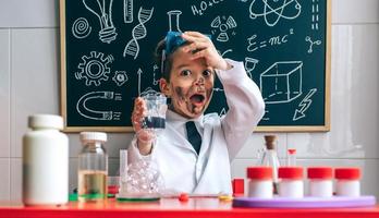 Funny boy chemist with dirty face photo