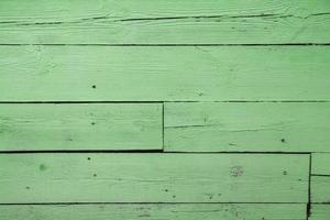 Old grungy wooden planks background in green color photo