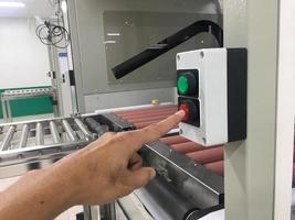 hand touch on button machine in factory industrial photo